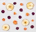 Dried carrot, beet, apple chips on a white concrete background. Organic natural food