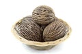 Dried cerbera oddloam's seed, pong pong seeds in basket on white