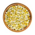 Dried chamomile blossoms, camomile tea in wooden bowl Royalty Free Stock Photo