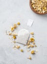 Dried chamomile in a tea bag and a wooden bowl. Healthy food and drink concept. Herbal and alternative medicine with dry herbs Royalty Free Stock Photo