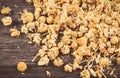 Dried chamomile on wooden board. Alternative medicine and herbalism