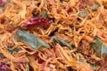 Dried chicken meat with chili pepper and spices with bay leaves close up. Asian style of food.