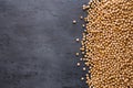 Dried chickpeas on dark surface with border