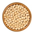 Dried chickpeas in wooden bowl over white