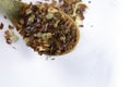 Dried chili flakes on wooden spoon against white background. Close up view of crushed red cayenne pepper. Top view of dried red Royalty Free Stock Photo