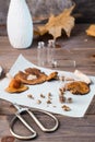 Dried chopped fly agarics stacked in a small jar and dry mushrooms on parchment and scissors on a wooden table. Microdosing and Royalty Free Stock Photo