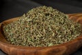 Dried chopped provence herbs in a wooden bowl