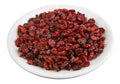 Dried Christmas cranberry berries on a white glass plate isolated