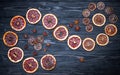 Dried citrus fruits, orange, lime, grapefruit, anise. Dark natural wooden background. Flat lay, top view, copy space. Autumn theme Royalty Free Stock Photo