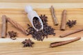 Dried cloves, star anise fruits, cinnamon sticks on wooden surface Royalty Free Stock Photo