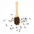 dried cloves wooden spoon on white