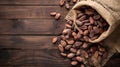 Dried cocoa beans and dried cocoa pods on wooden background