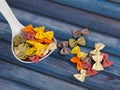 Dried colorful Italian pasta farfalle or bows with spoon Royalty Free Stock Photo