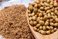 Dried coriander seeds in a spoon with coriander powder background, Indian cuisine herbs Royalty Free Stock Photo