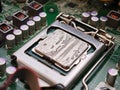 Dried cracked thermal paste on CPU in motherboard socket with cooler removed, macro closeup of computer processor and LGA bracket Royalty Free Stock Photo