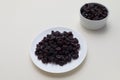 Dried Cranberries On White Plate On Beige Background. Superfood. Selective Focus. Sweet