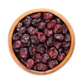 Dried large cranberries, American cranberries or bearberries, in wooden bowl