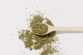 Dried and crushed oregano herb spice in a wooden spoon on a white background. The concept of aromatically prepared dishes, Royalty Free Stock Photo