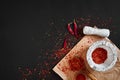 Dried and crushed red chili pepper in stone mortar. Copy space Royalty Free Stock Photo