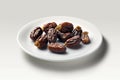 Dried date fruits on a round white plate with white background. Created with generative AI technology.