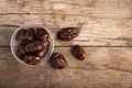 Dried date palm in cup on wooden floor. Royalty Free Stock Photo