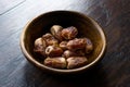 Dried date palm fruits or kurma, ramadan ramazan Medjool food in wooden bowl.