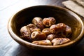 Dried date palm fruits or kurma, ramadan ramazan Medjool food in wooden bowl.