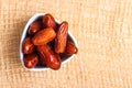 Dried dates in bowl on table background Royalty Free Stock Photo