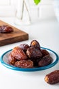 Dried dates in the bowl on white background. Royalty Free Stock Photo