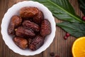 Dried dates exotic fruit on a plate in a rustic style. Wooden background. Top view. Close-up Royalty Free Stock Photo