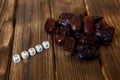 Dried dates lie on a wooden table, next to the explanatory inscription