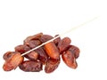 Dried dates with plastic stick, stem, isolated on white background