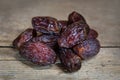 Dried dates on wooden table, sort medjool, sweet vegan superfruit