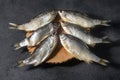 Dried dry fish vobla, with caviar laid out on a dark background