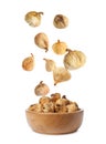 Dried fig fruits falling into bowl on background Royalty Free Stock Photo