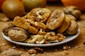 Dried fig and whole and cracked walnuts on white ceramic plate Royalty Free Stock Photo