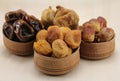 Dried figs, dates, dried apricots in a wooden circular shape