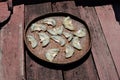 Dried fish fillet on wooden background. Snack on fish with beer, Pieces of salt cod fish. Slices of stockfish on wooden plate. Royalty Free Stock Photo