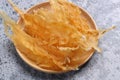 Dried fish maw on wooden table.