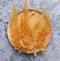 Dried fish maw on wooden table.