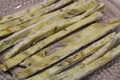 Dried fish straws on a plate on the table.