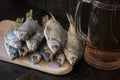 Dried fish on a wooden board and a mug of beer on a wooden background.