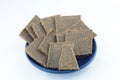 Dried flax bread on blue plate Royalty Free Stock Photo