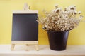 Dried flower and space blackboard on wooden background Royalty Free Stock Photo