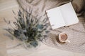 Dried flowers and a cup of cappuccino  with book, spring concept. top view. flatlay Royalty Free Stock Photo