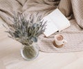 Dried flowers and a cup of cappuccino  with book on wooden background. top view. flatlay Royalty Free Stock Photo