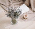 Dried flowers and a cup of cappuccino  with book on wooden background. top view. flatlay Royalty Free Stock Photo