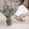 Dried flowers and a cup of cappuccino  with book on wooden background. top view. flatlay Royalty Free Stock Photo