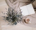 Dried flowers and a cup of cappuccino  with book on wooden background. top view. flatlay Royalty Free Stock Photo