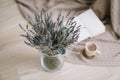 Dried flowers and a cup of cappuccino  with book on wooden background. top view. flatlay Royalty Free Stock Photo